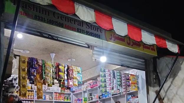 A store with a red and white awning

Description automatically generated